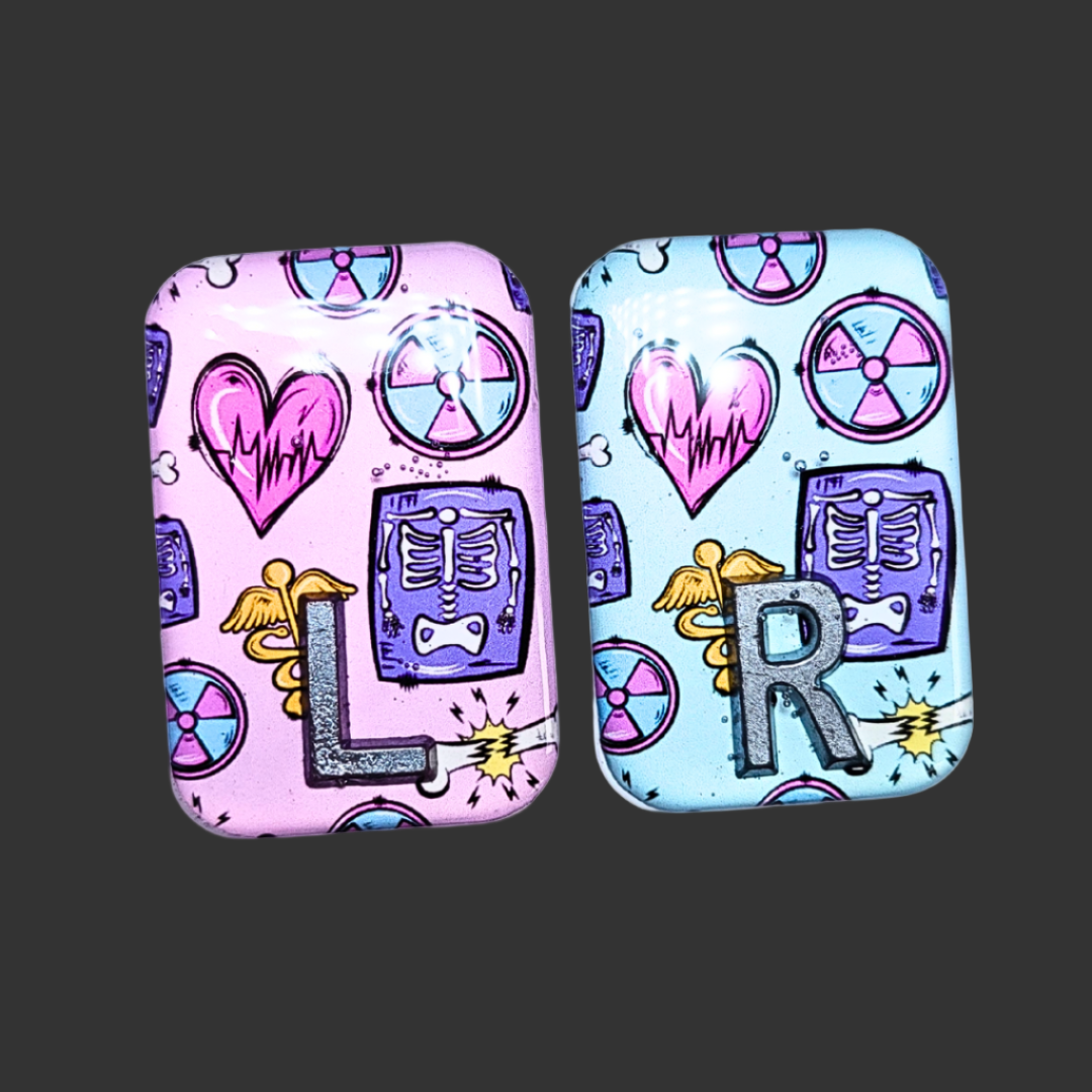 X RAY MARKERS THAT ARE PINK AND TEAL WITH X RAY SYMBOLS ON, RADIOGRAPHER AND X RAY TECH MARKERS