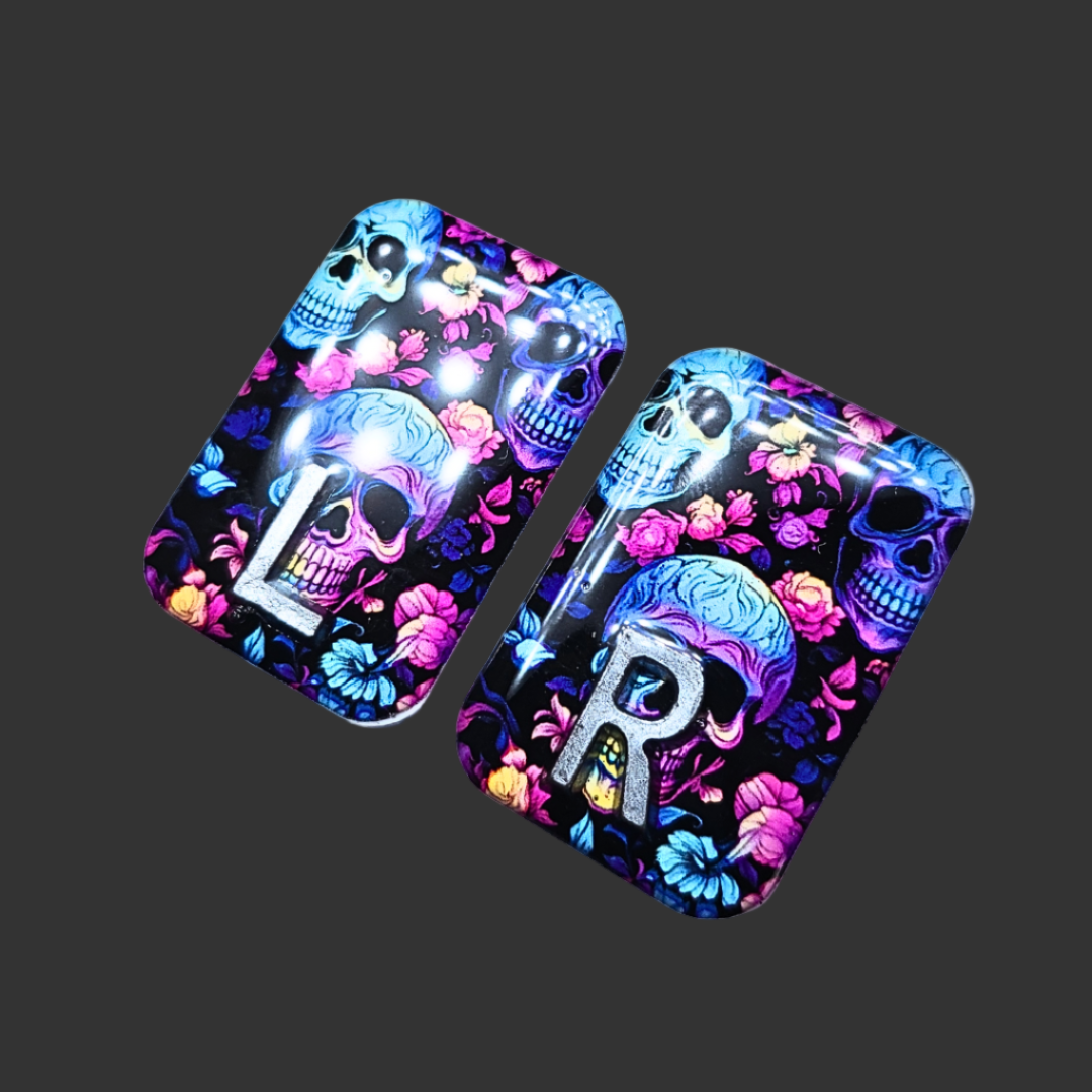 Handmade skull X-ray markers in bright black, pink, purple, and teal colours for radiographers.