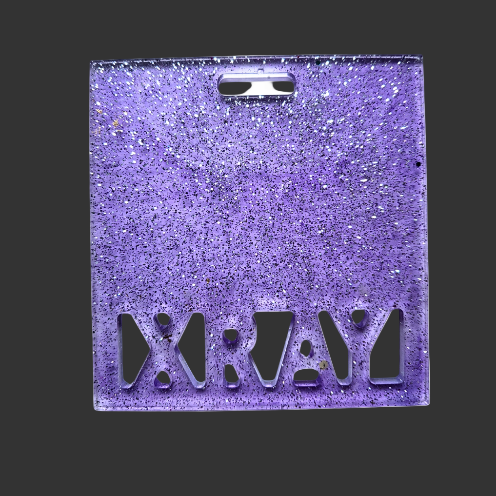 Badge buddy in assorted colours designed to hold X-ray markers. for radiographers and x ray techs