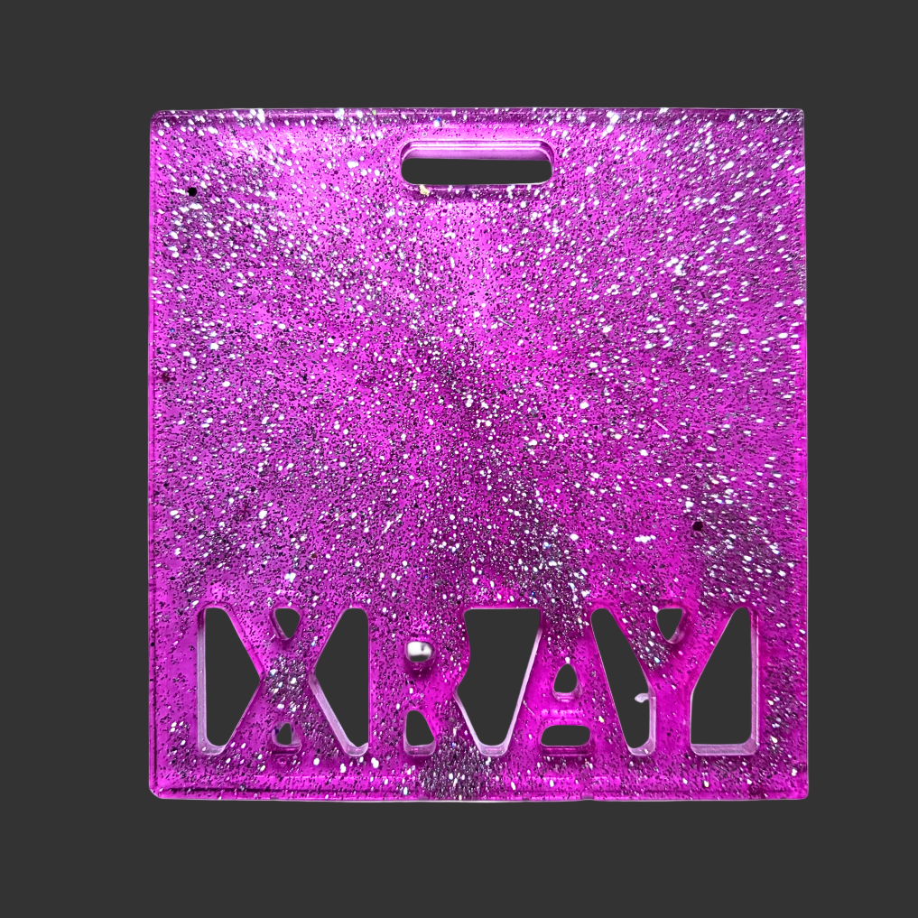 Customizable badge buddy for attaching X-ray markers in plain or glitter finish.