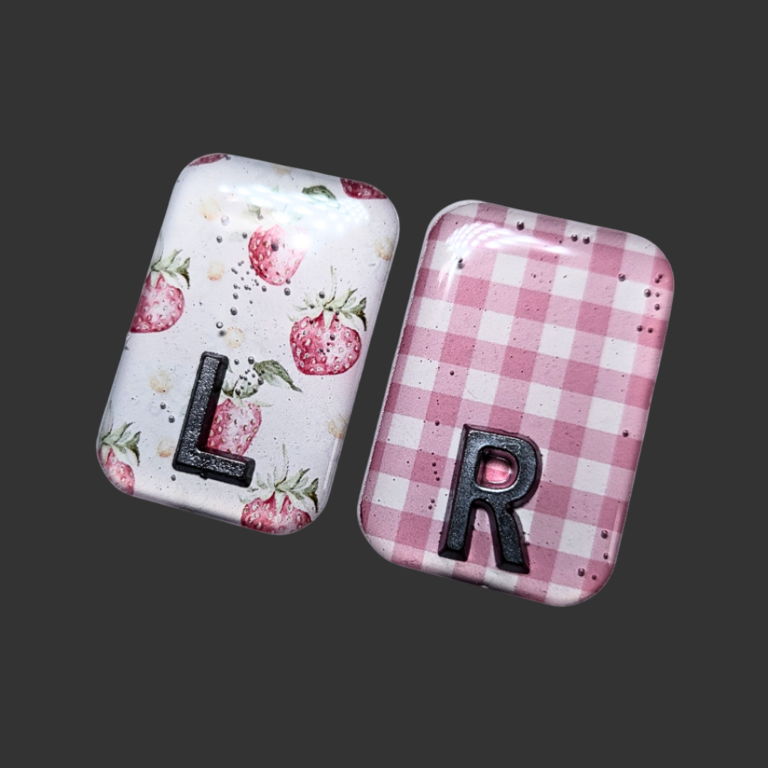 Strawberry-themed X-ray markers with a pink and white checked pattern and custom initial