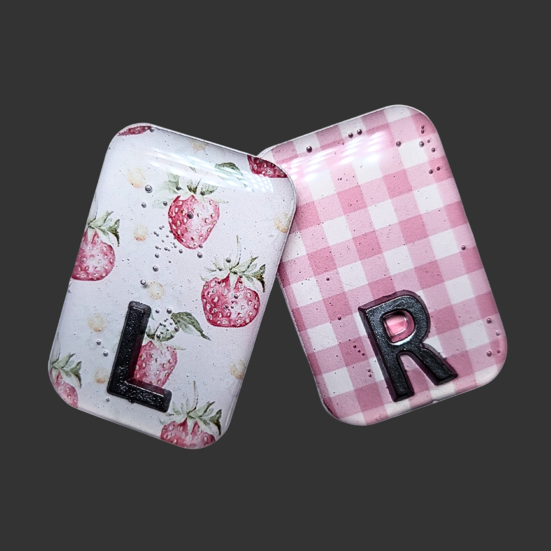 Strawberry-themed X-ray markers with a pink and white checked pattern and custom initial