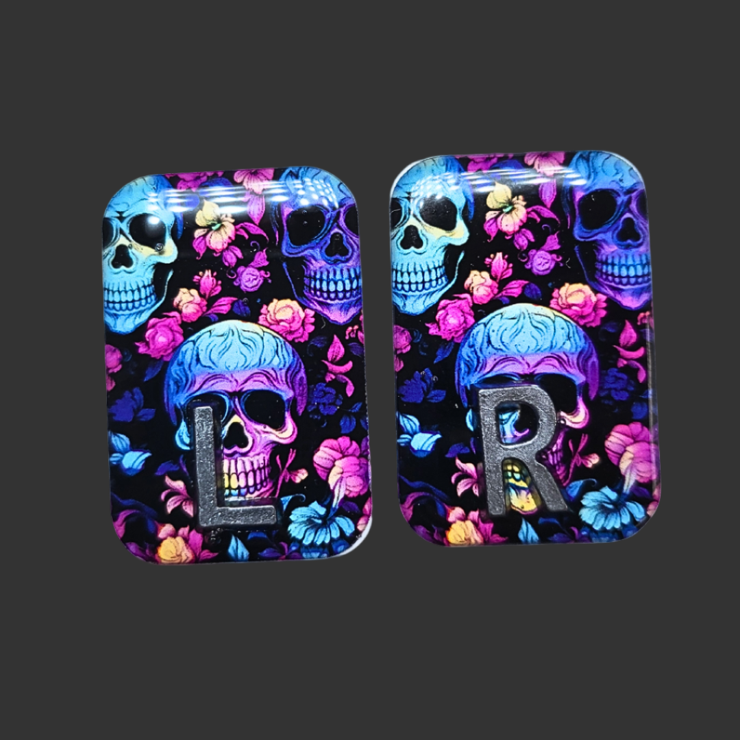 Handmade skull X-ray markers in bright black, pink, purple, and teal colours for radiographers.