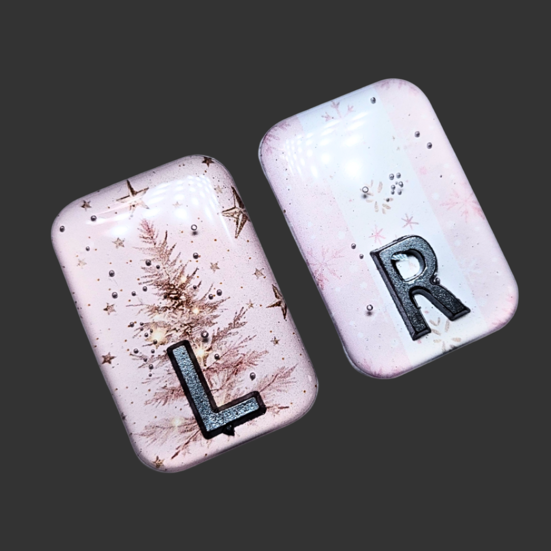 Baby pink Christmas-themed X-ray markers with tree and wrapping paper designs