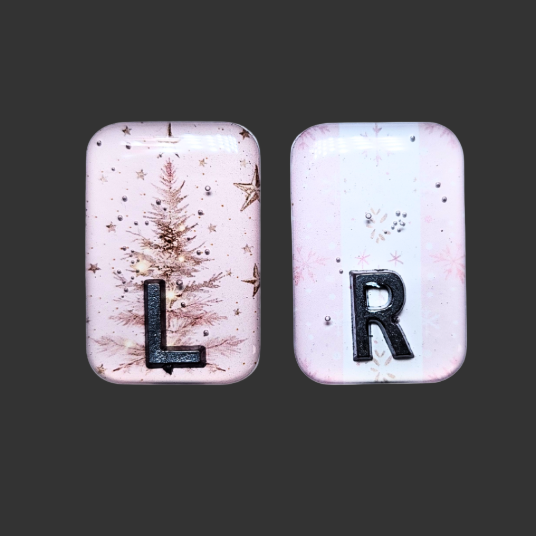 Baby pink Christmas-themed X-ray markers with tree and wrapping paper designs