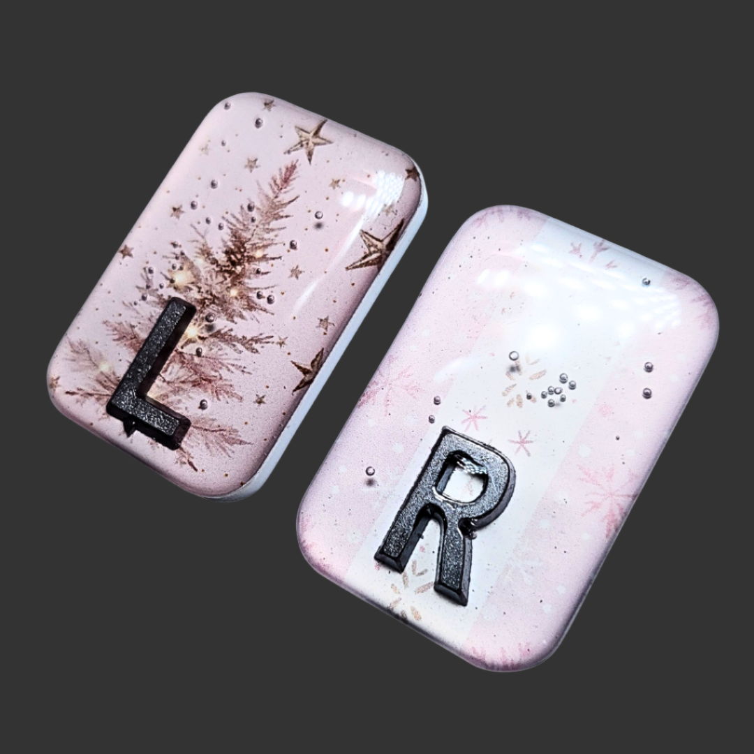 Baby pink Christmas-themed X-ray markers with tree and wrapping paper designs