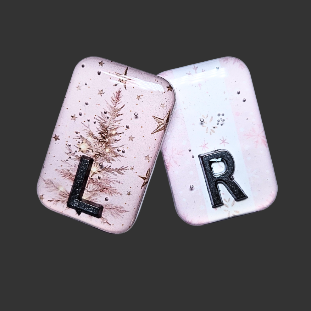 Baby pink Christmas-themed X-ray markers with tree and wrapping paper designs