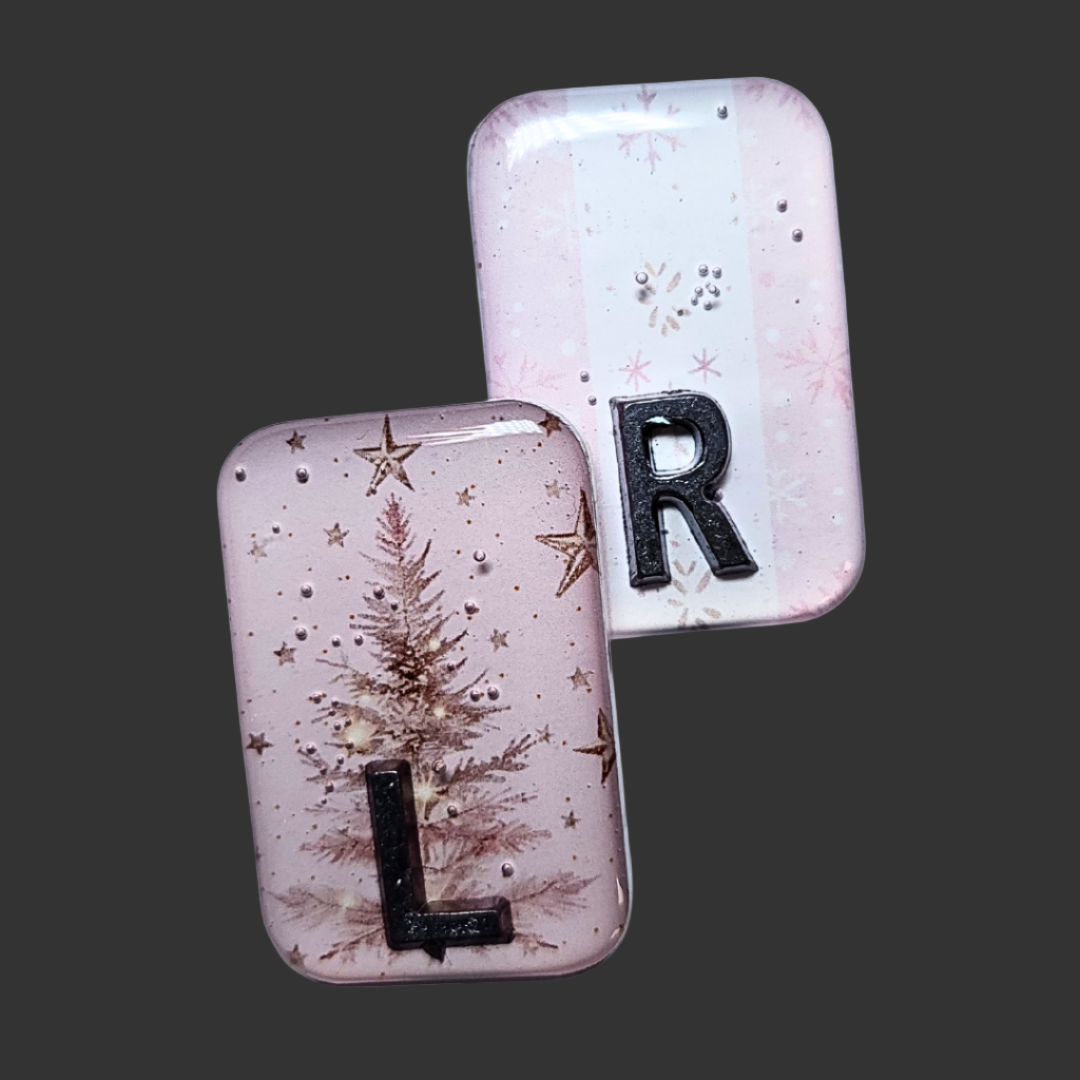 Baby pink Christmas-themed X-ray markers with tree and wrapping paper designs