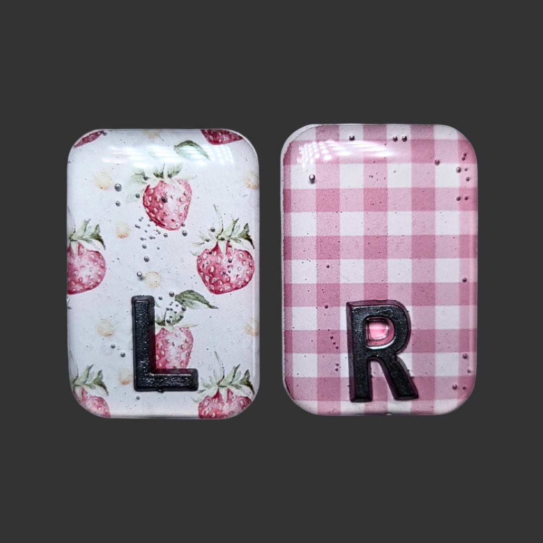 Strawberry-themed X-ray markers with a pink and white checked pattern and custom initial